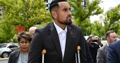 Australian tennis player Nick Kyrgios, center, arrives at the ACT Magistrates Court in Canberra, Friday, Feb. 3, 2023. Kyrgios has pleaded guilty in an Australian court to assaulting a former girlfriend during an argument in January 2021. (Mick Tsikas/AAP Image via AP)