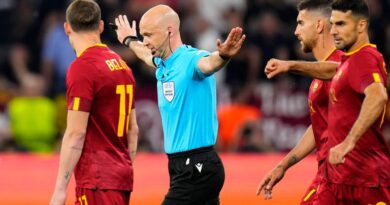 Referee Anthony Taylor signals no penalty for Sevilla after checking the VAR during the Europa League final