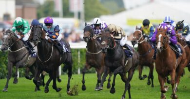 Asjad ridden by jockey P.J. McDonald (gold and black) wins the Cazoo Handicap at Doncaster