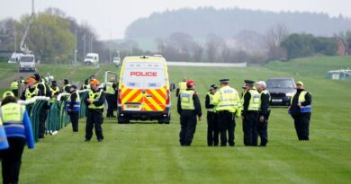 Police and security clear the track at Ayr after protestors targeted the Scottish Grand National meeting