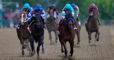 John Velazquez, right, atop National Treasure win the Preakness at Pimlico